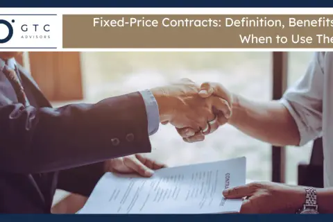Two businessmen shake hands over a contract, signifying a firm fixed contract agreement.